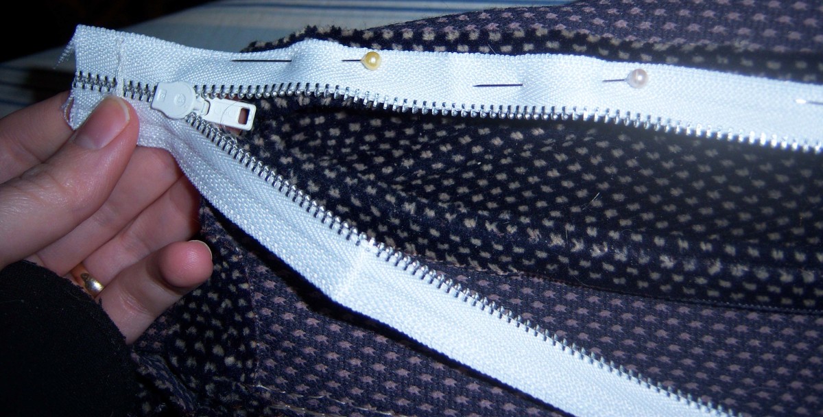 One side of the zipper is pinned in place.