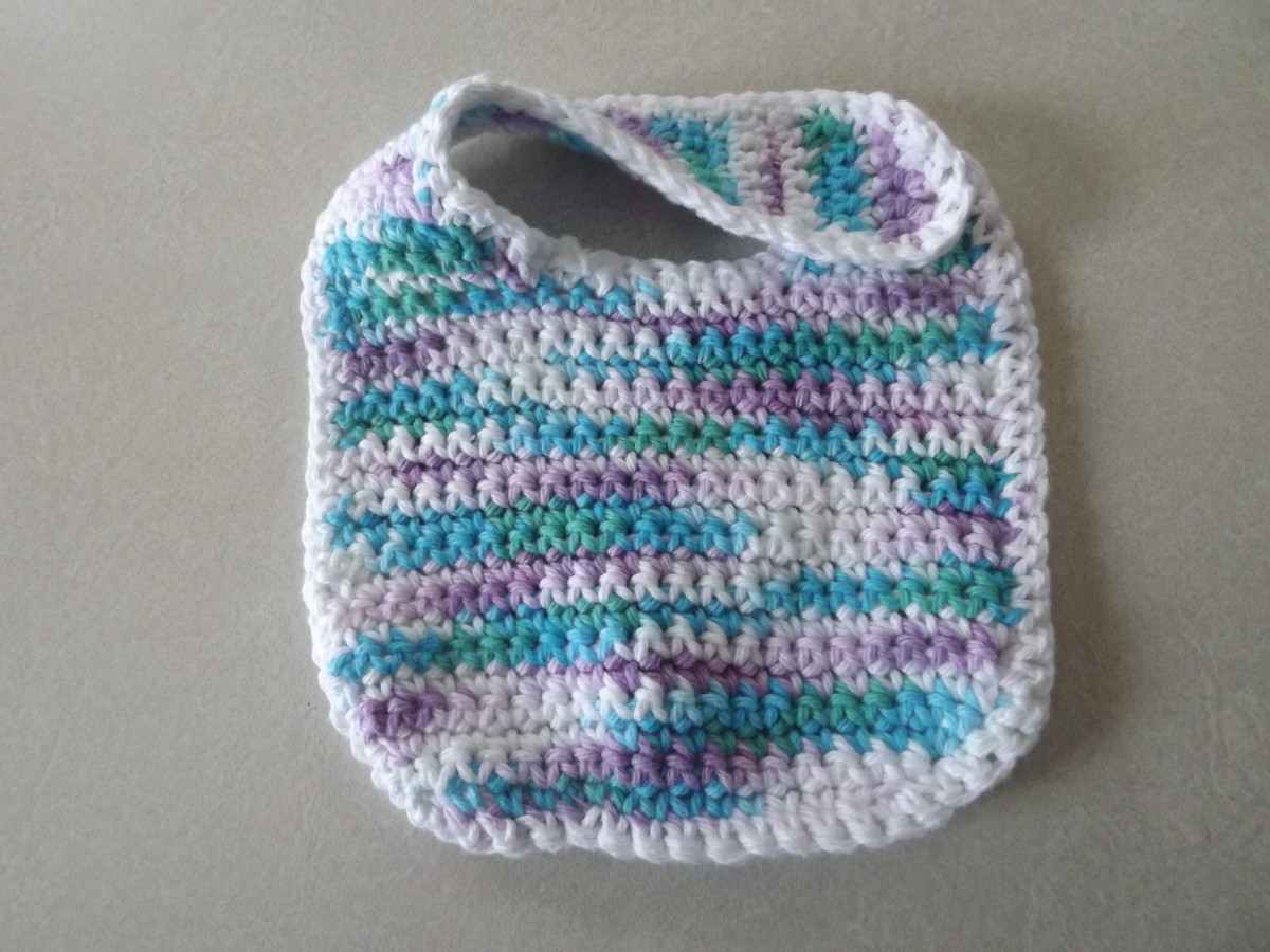 This bib snaps to the side, so you don't need to lift baby's head when snapping. See the side snap baby pattern below.