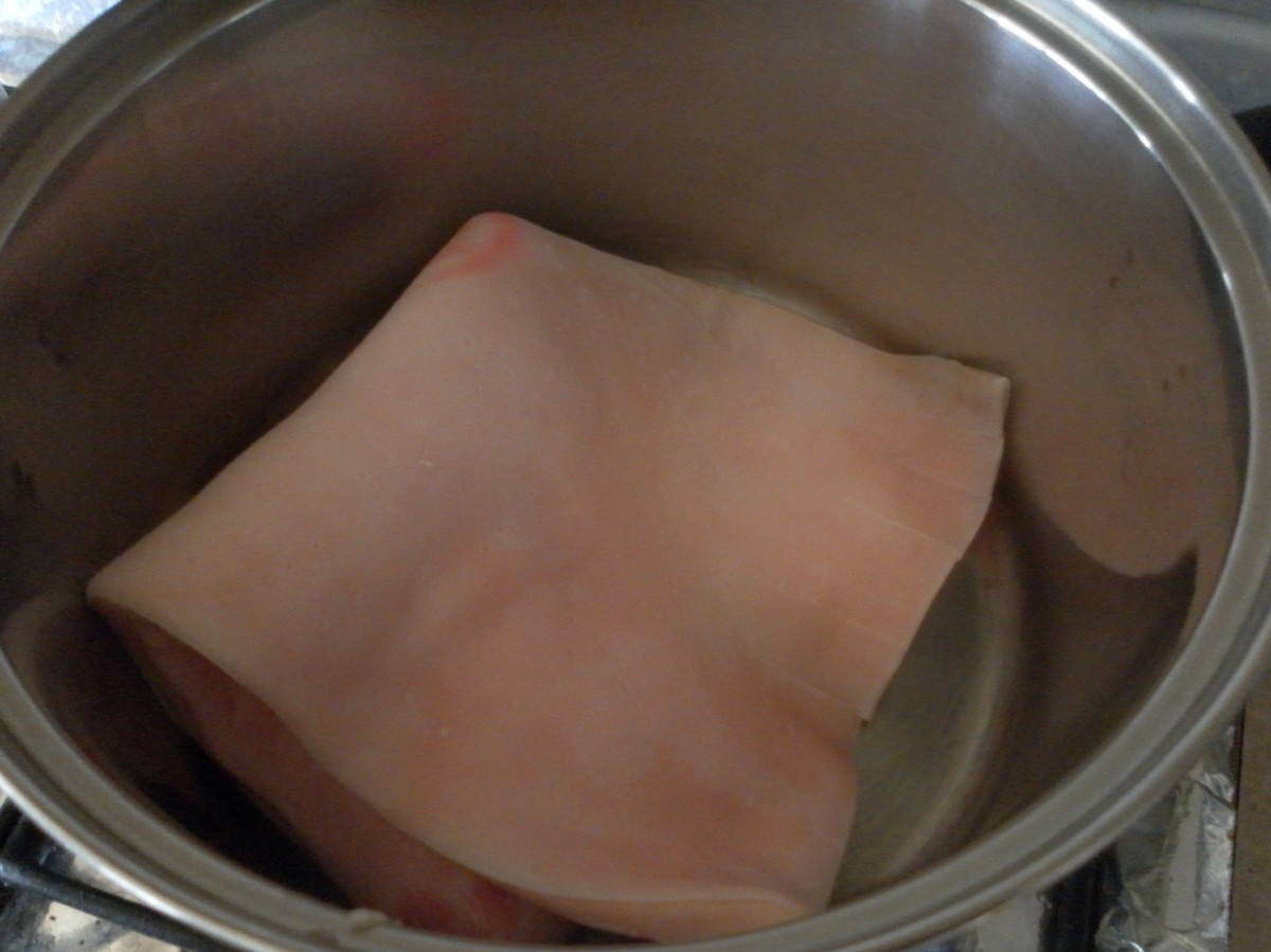Pork rind in the pot ready to be boiled.