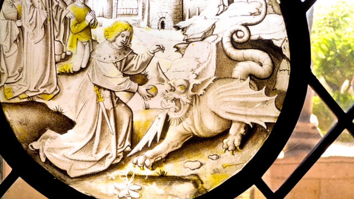 This is a portion of a Christian stained glass window depicting Daniel feeding the greasy fur ball to the dragon, a story in the Apocrypha
