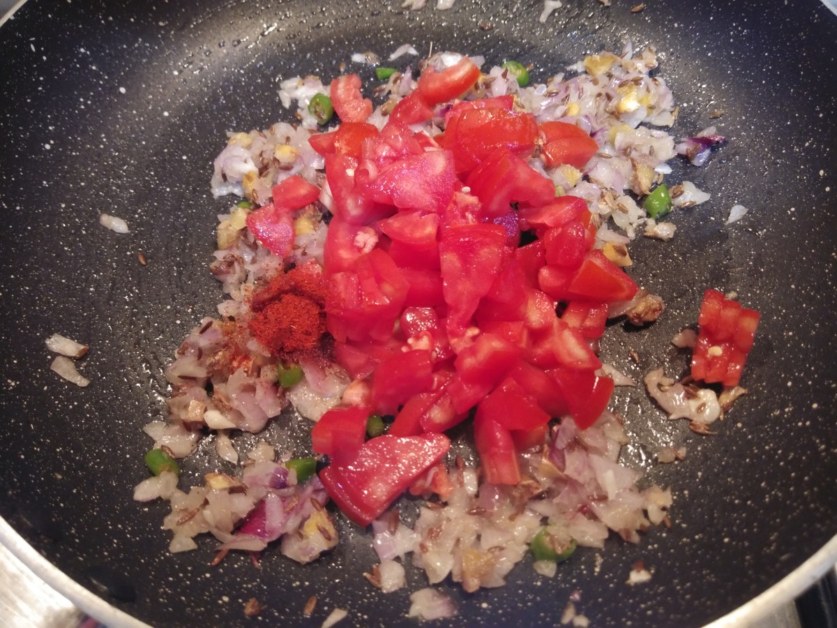 Add chopped tomatoes and red chili powder.