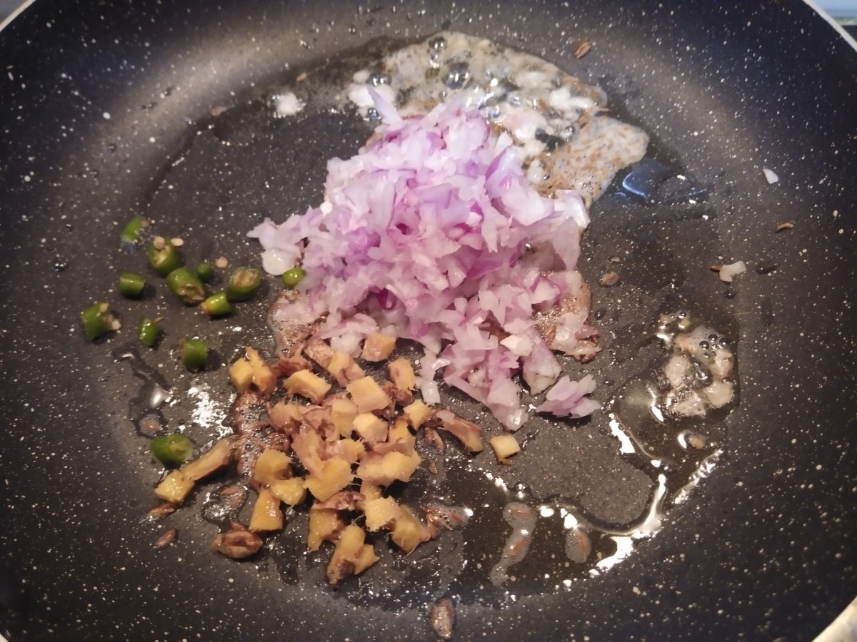 Add finely chopped onion, ginger and green chilies.