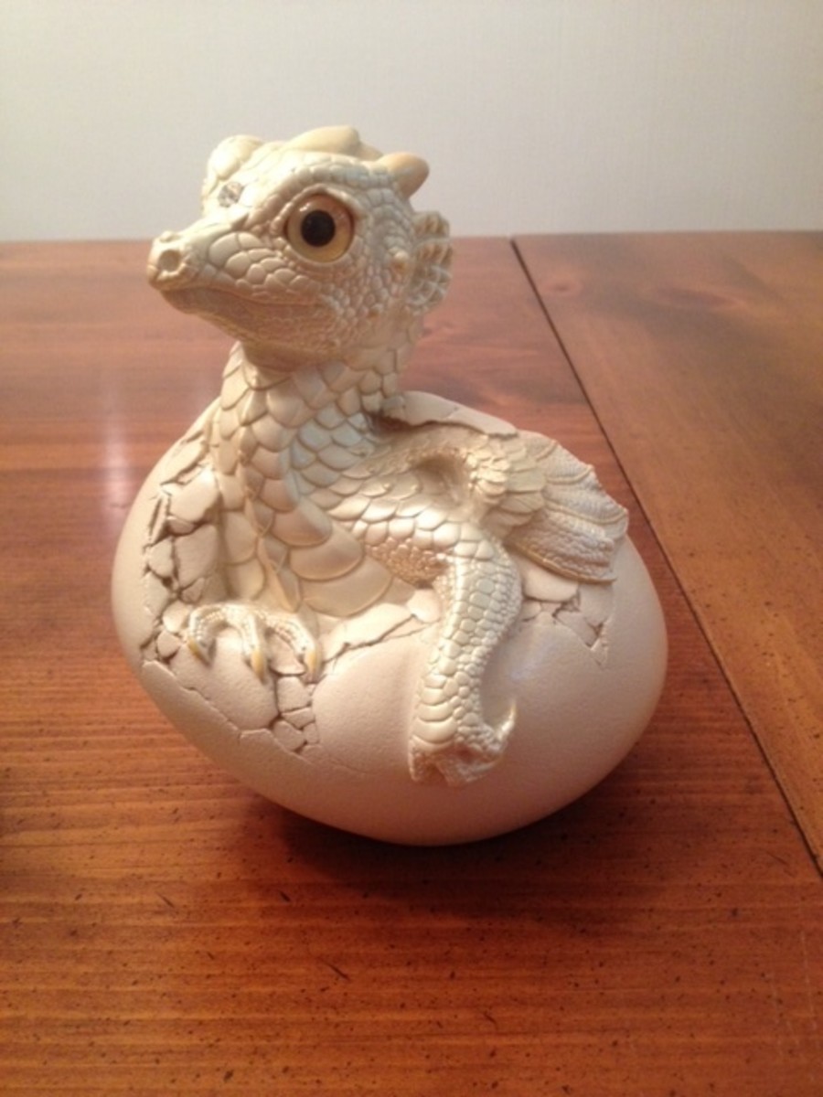 This is a rare hatching dragon figurine from the Ivory Windstone Edition collection.