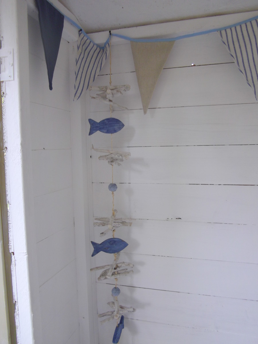 Hanging wall art with a seaside theme suitable for a beach hut garden room.