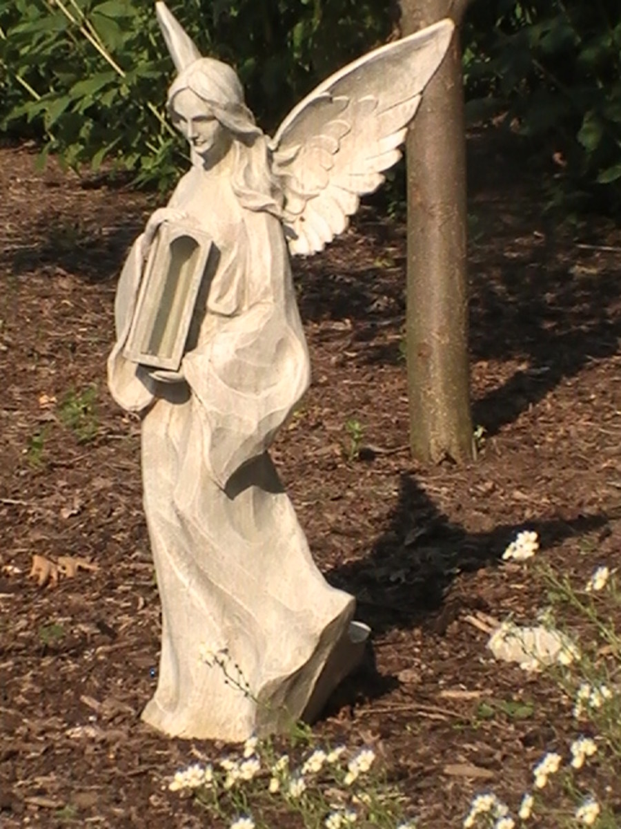 Angel statue along Geneva Lake pathway.