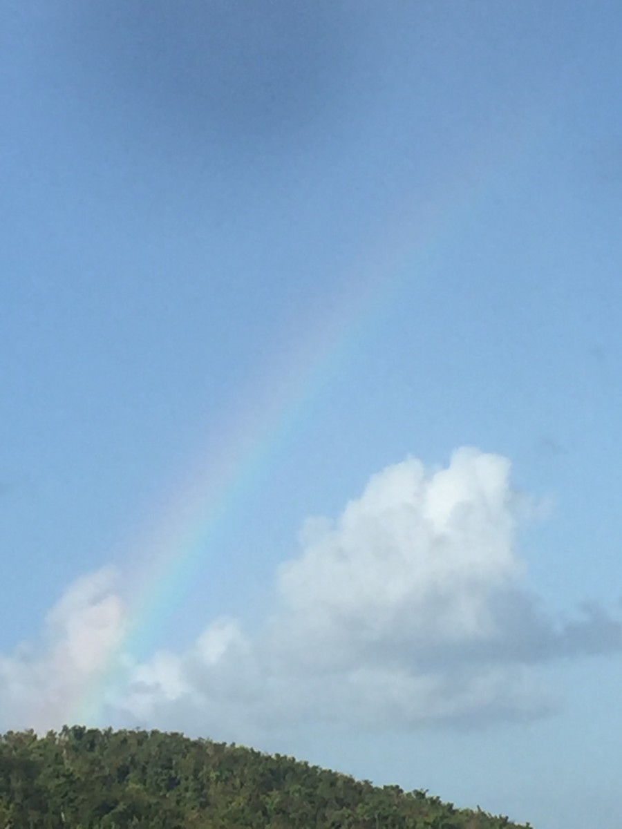 Captured 4:58pm on February 23, 2018. I was fixing my car brakes, when I look up. I notice a Rainbow. Incredible.....
