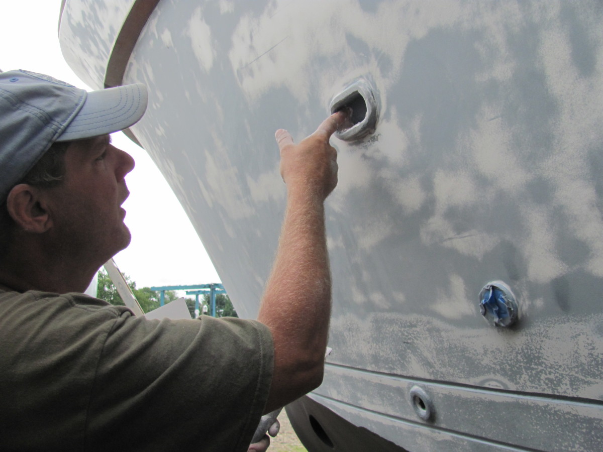 Luke applies some putty to fill in holes in the drain holes. 