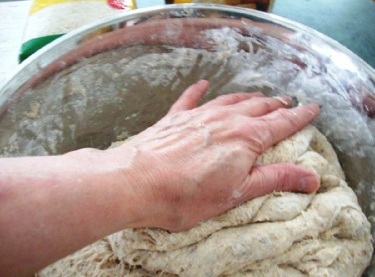 Folding bread dough over.