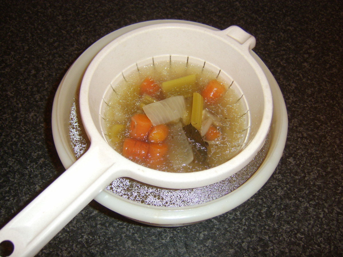 Cooled stock is strained through a colander or sieve