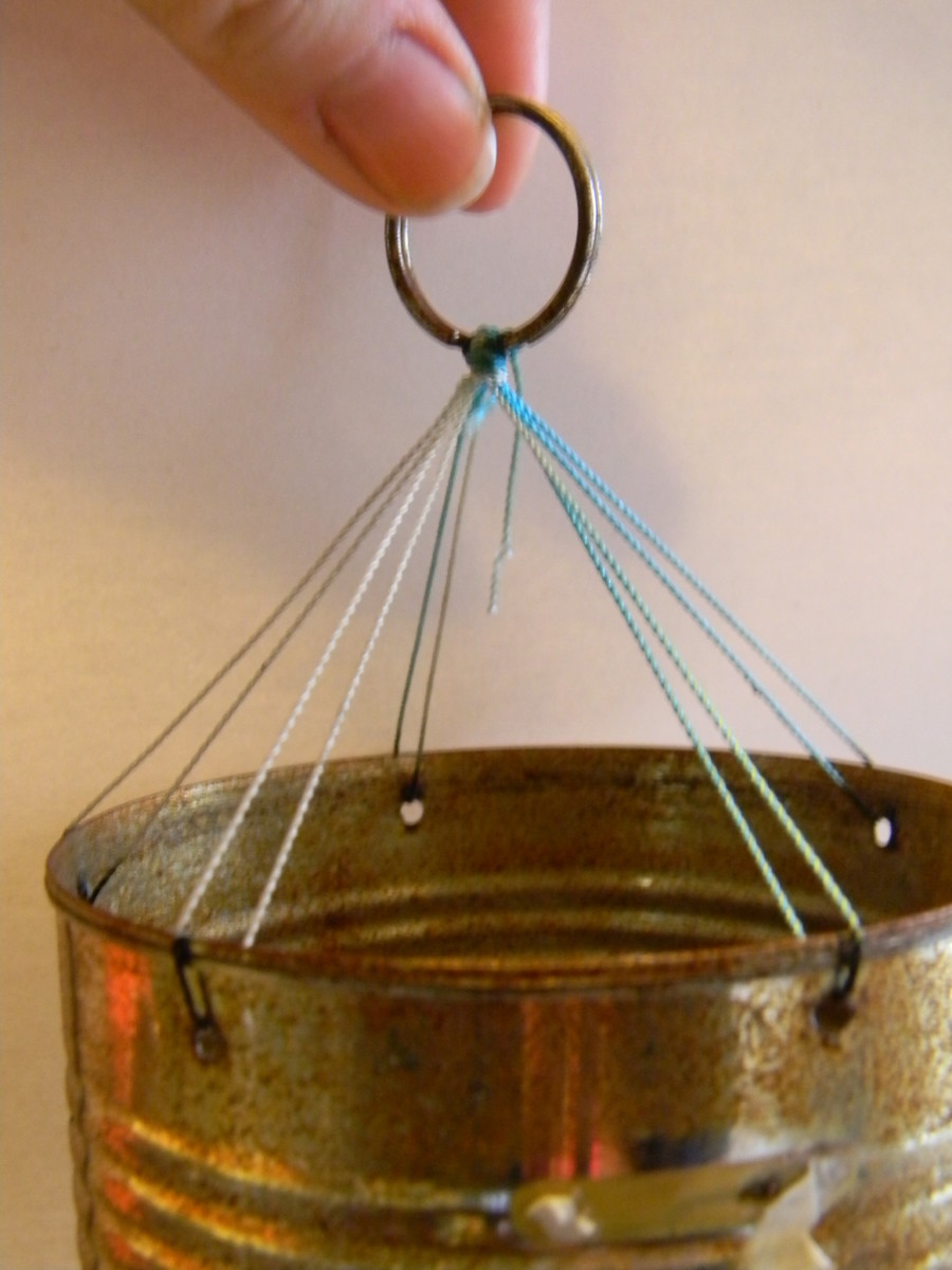 Use some kind of sturdy ring, like the loop from an old key ring, to create a hanger for the wind chime.