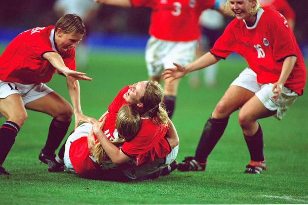 Dagny Mellgren (14) is congratulated by several players, including Ragnhild Gulbrandsen (16) after scoring the winning goal against the USA in the gold medal match of the 2000 Summer Olympics.