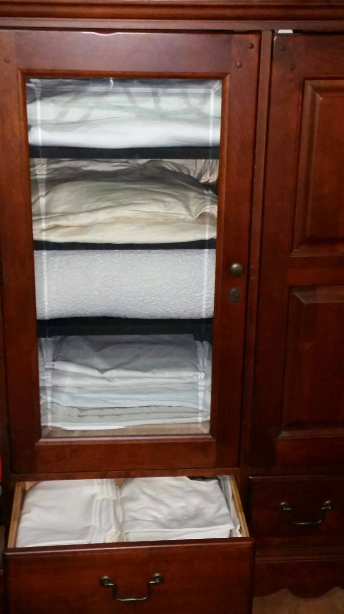 Who would think to turn an entertainment center into a linen cupboard? Juhls thought to do this and it's great. The shelves and drawers are great for holding linens.