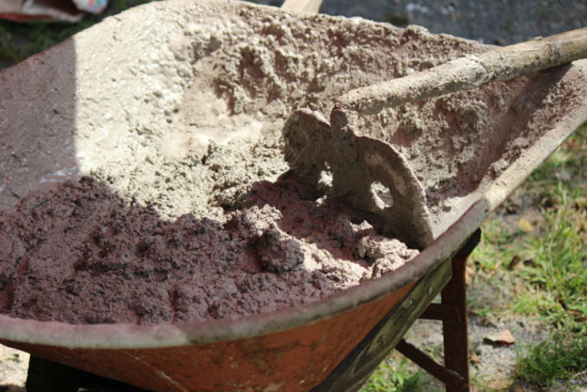 Mix concrete and water in a wheelbarrow