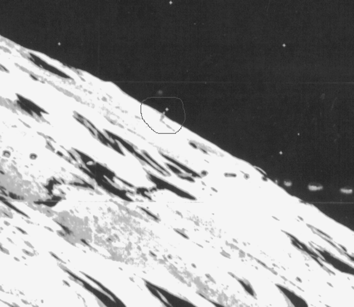 The Shard On The Moon. What is the object circled in the photo? Was it built by aliens.If it is a structure it would be huge. See the shadow it casts. 