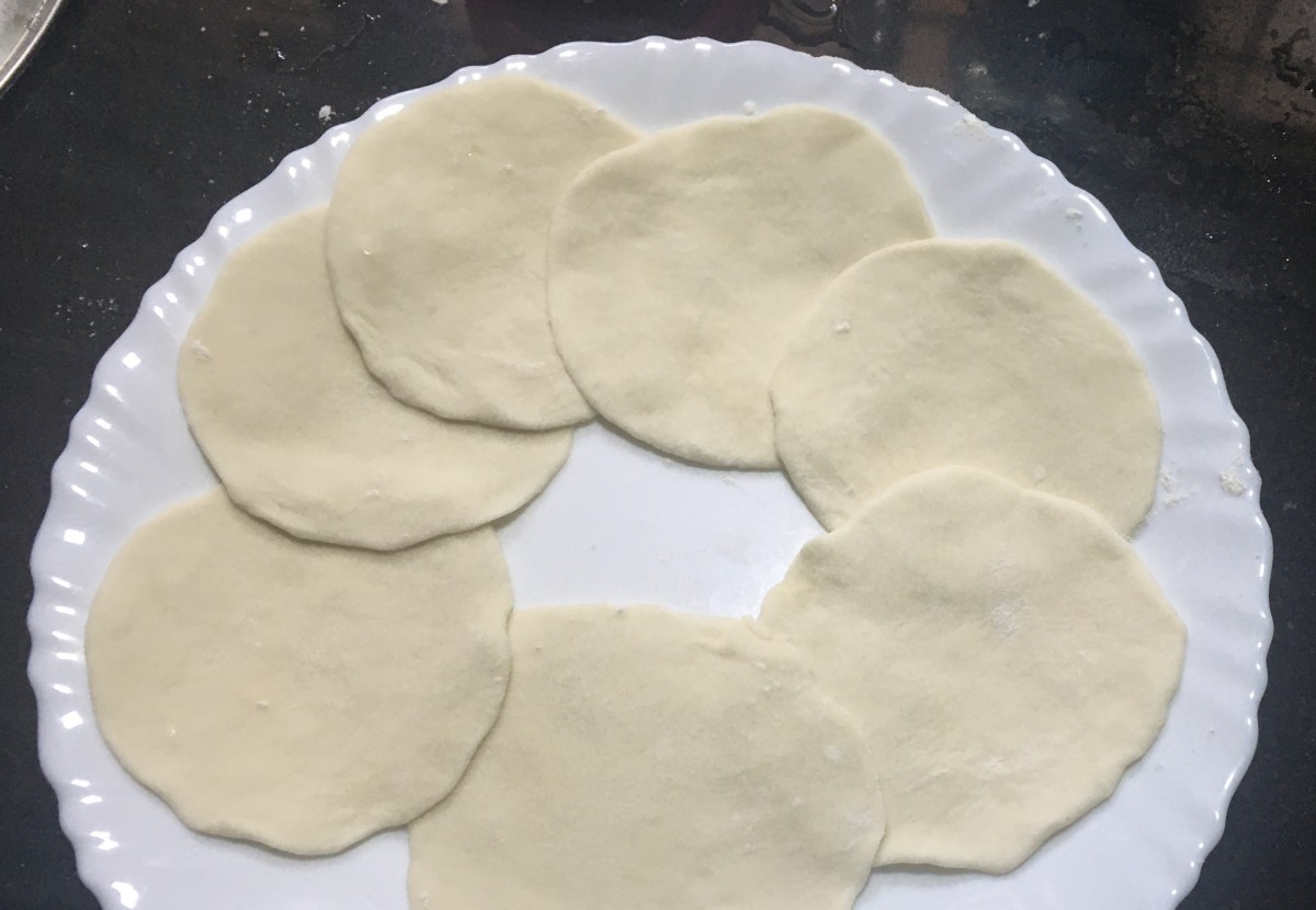 Roll out each dough ball into a thin circle.