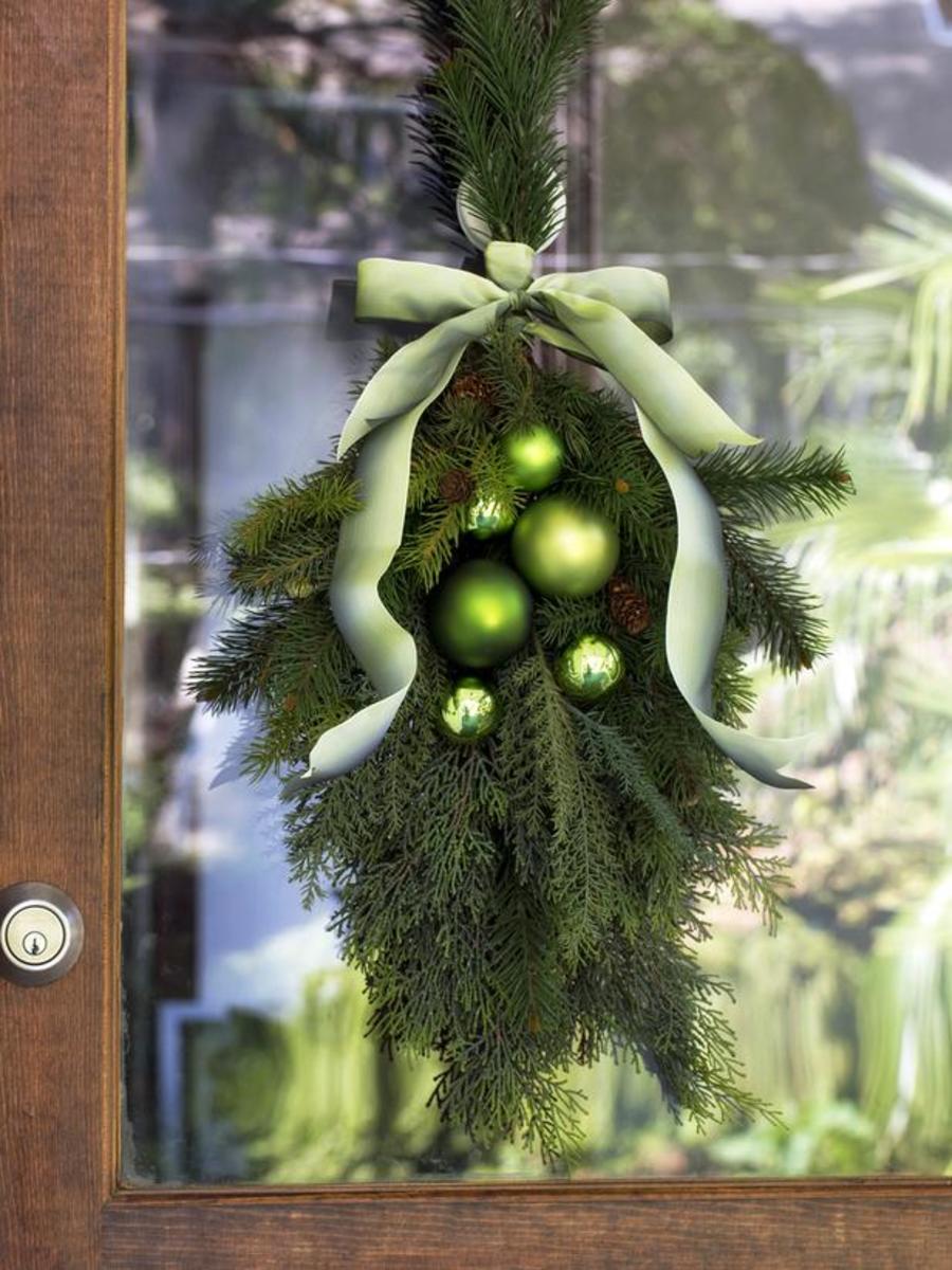 You can make a lovely window wreath with beautiful green sprays of evergreen tied with a decorative bow.