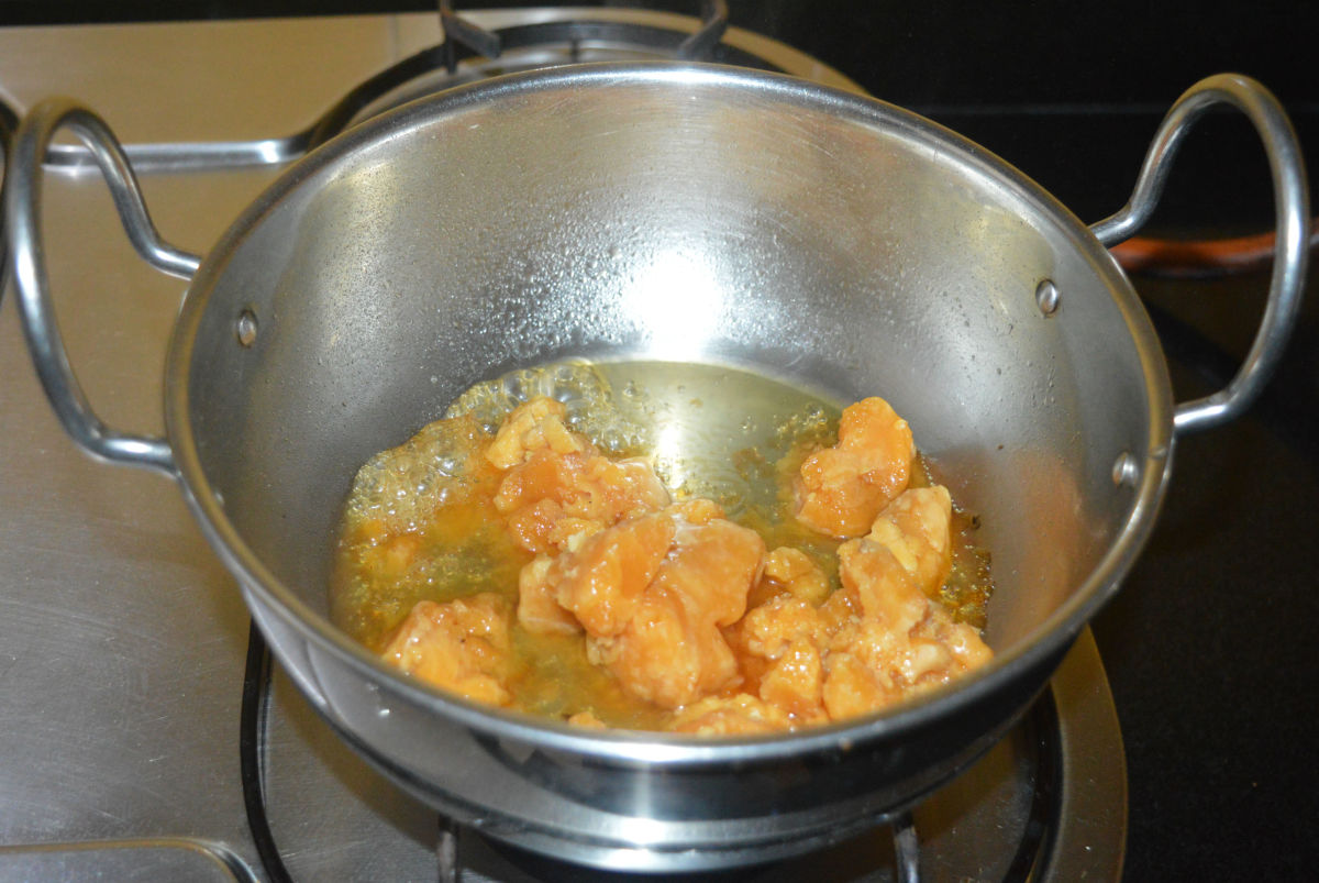 Step three: Add jaggery powder and some water to a deep-bottomed pan. Keep the heat at medium. Keep stirring the mixture.