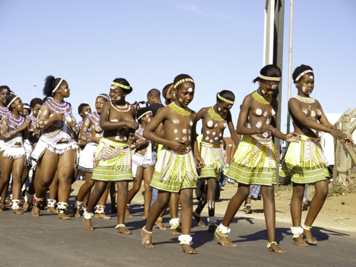Young bare breasted  Xhosa girls in traditional dress and in a procession