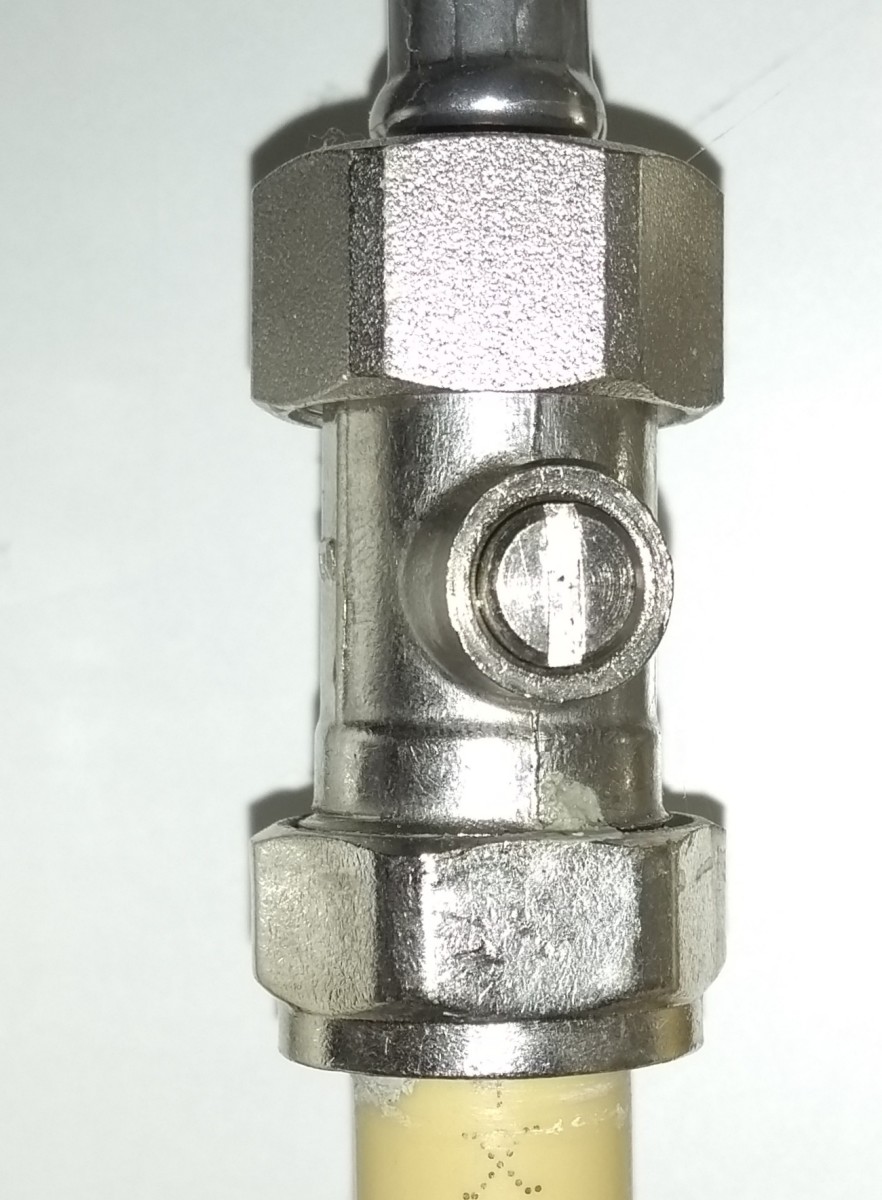 Miniature inline valve, which is opened/closed with a screwdriver. Turn so the slot is 90 degrees to the pipe.