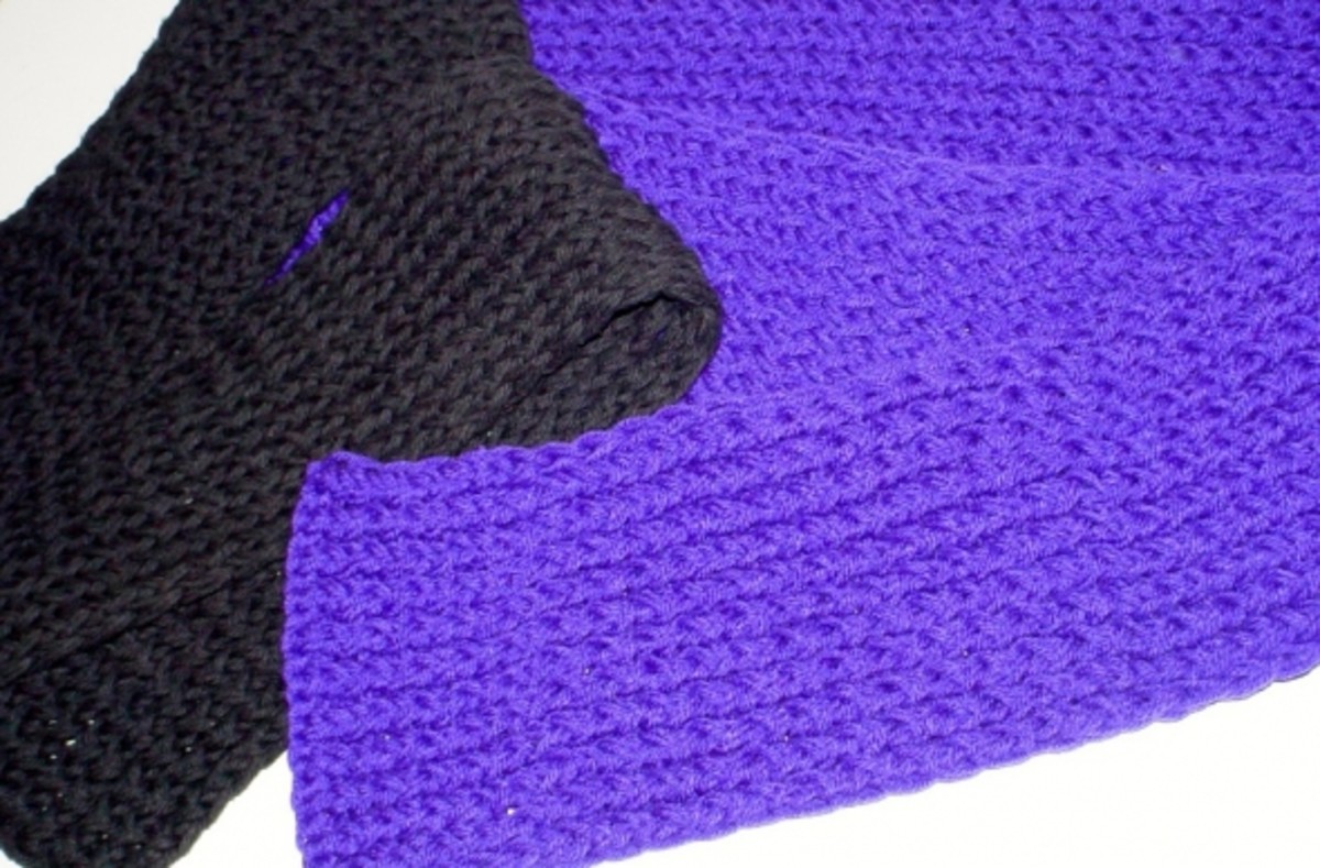 The purple and black winter scarves together. Made by wrapping the loom with two strands of yarn as if they were one... to make a heavier finished scarf.