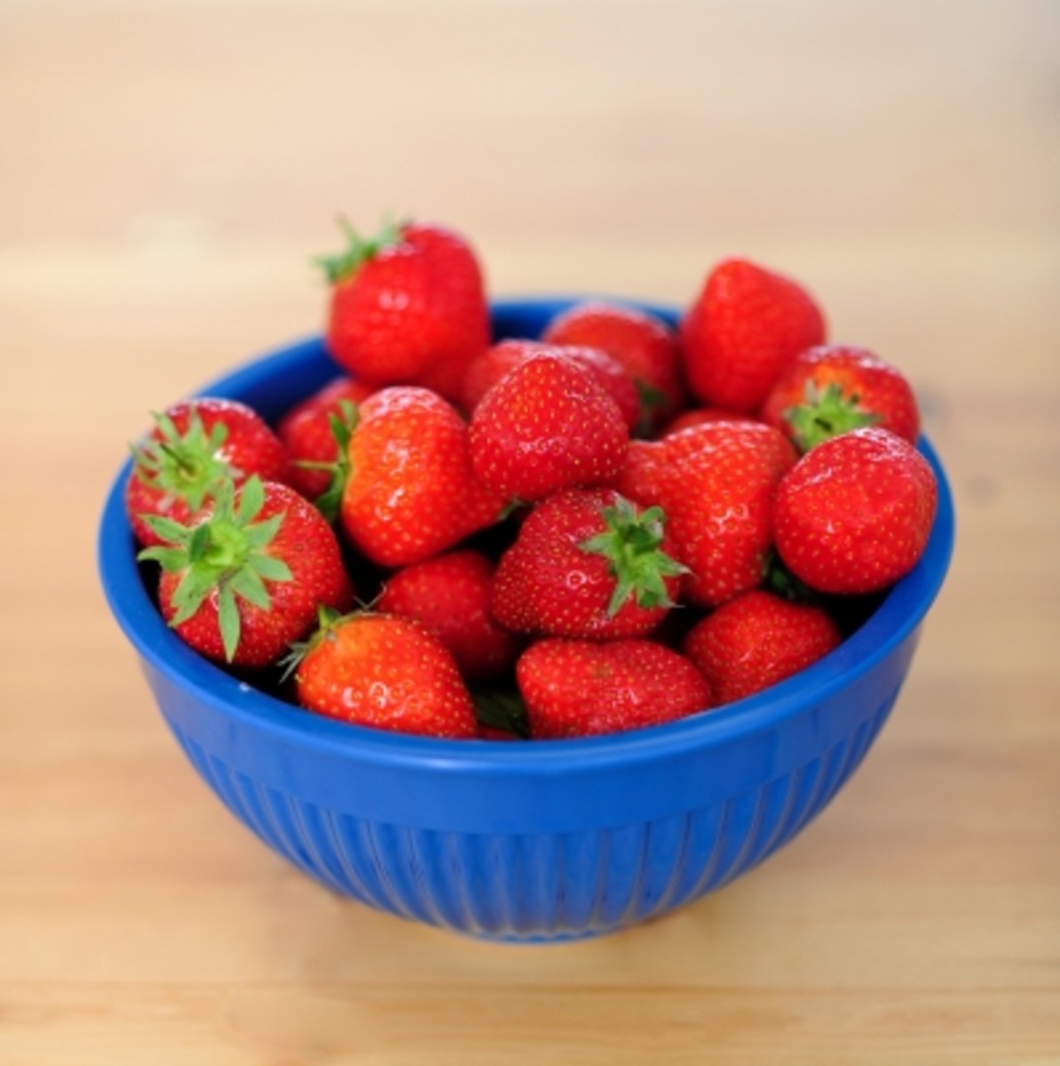 a bowl of strawberries =  homemade beauty products.
