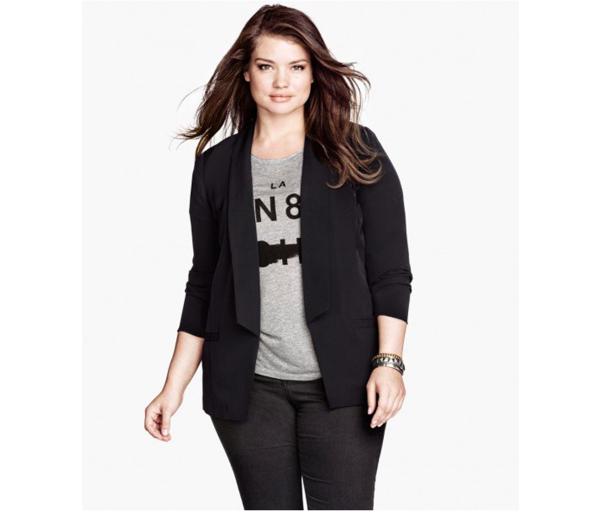 Hip-length blazer with long lapels, mock pockets at front, and vent at back