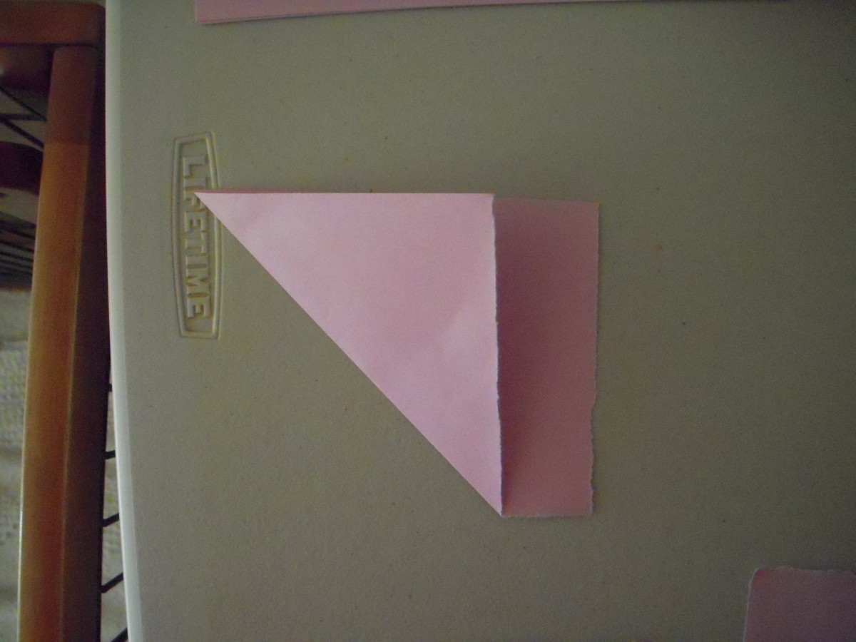 Fold one of the small rectangles diagonally to define a square. 