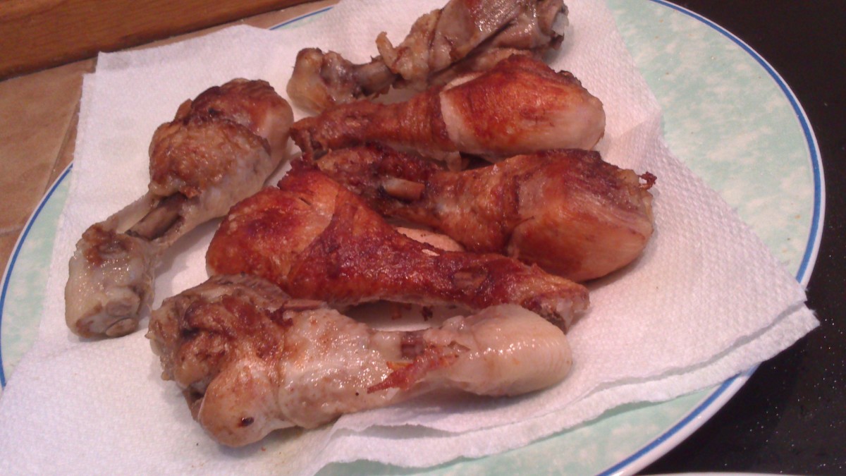 Browned chicken legs on kitchen paper to remove excess oil