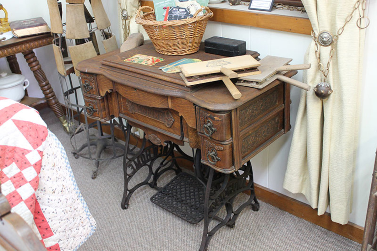 A typical vintage treadle sewing machine in the closed position.
