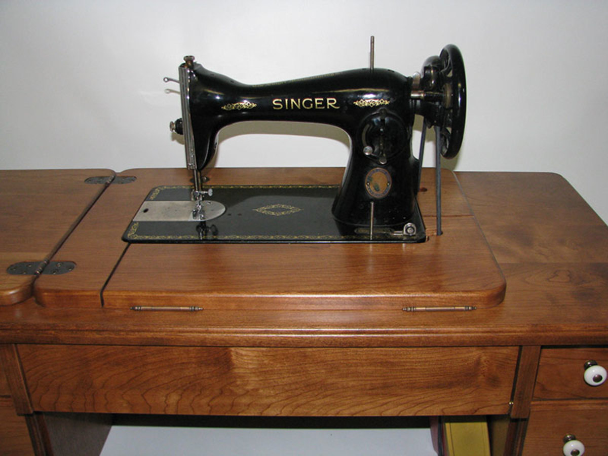An antique Singer Class 15 machine in the reproduction cabinet
