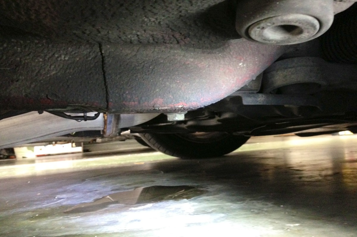 Sometimes, puddling underneath a car is good! This clear water is a sign of a strong-running A/C – pulling moisture from inside that condenses on the system-lines (which puddles beneath the car).