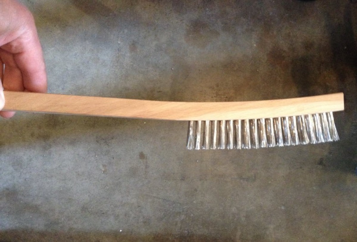 A wire brush for brushing away slag and spatter.