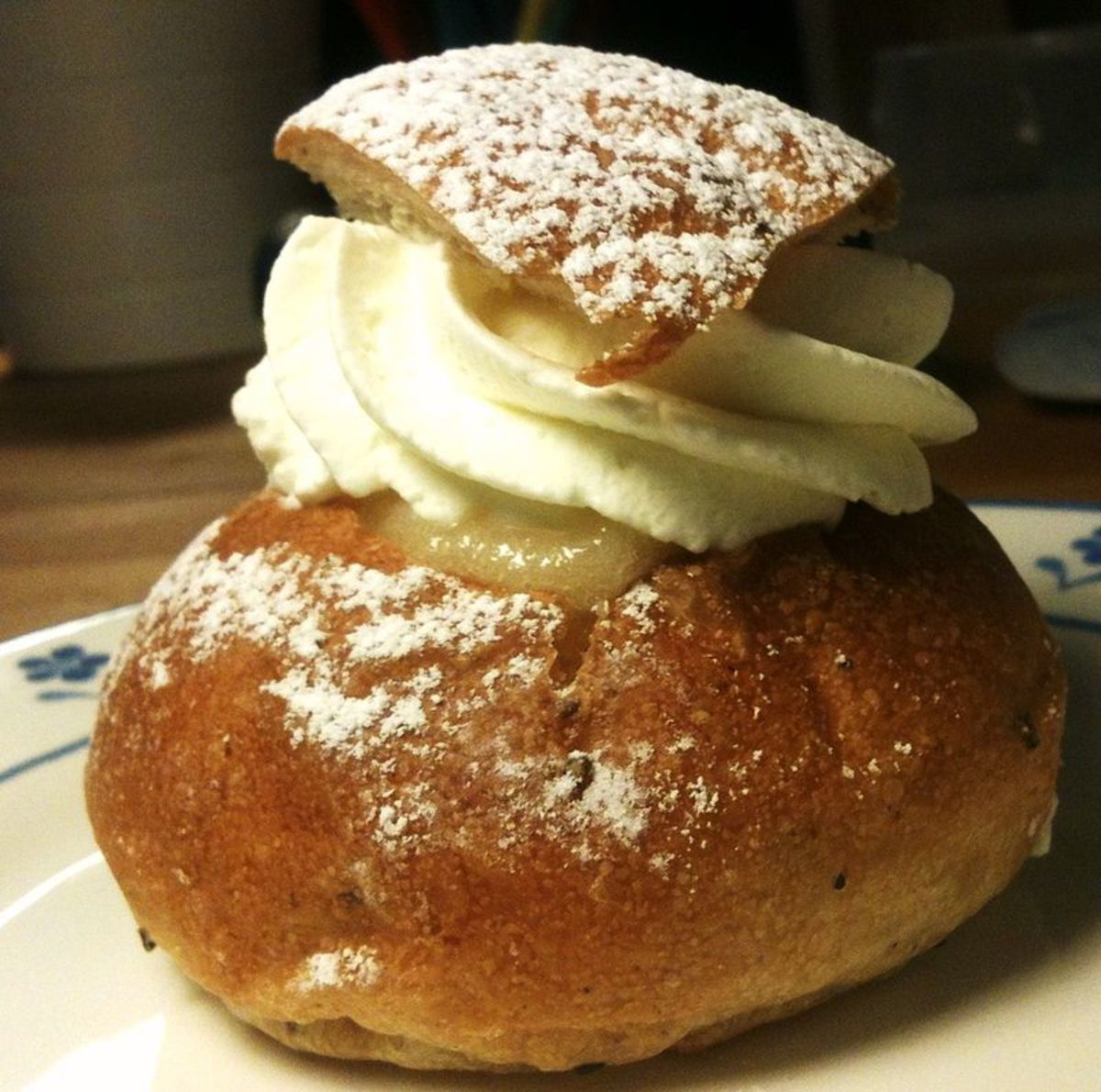 A delicious Semla cake. To learn more, and find out how to bake these, follow the link. Photo by Einarspetz on Wikimedia Commons.