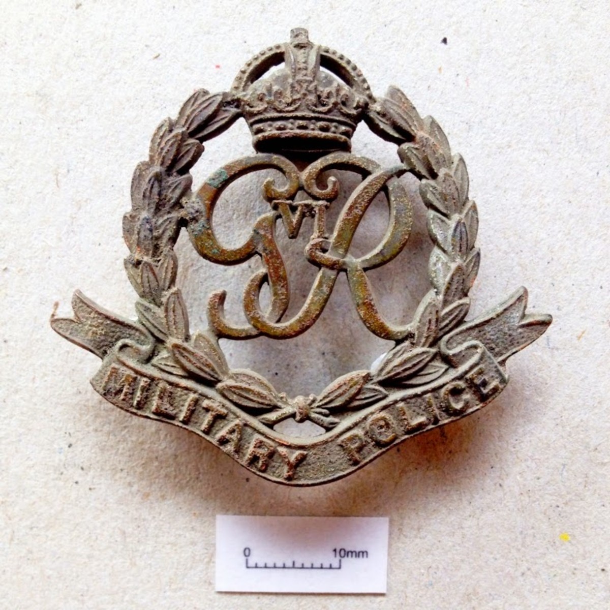 A Military Police cap badge, dated from between 1936-46.