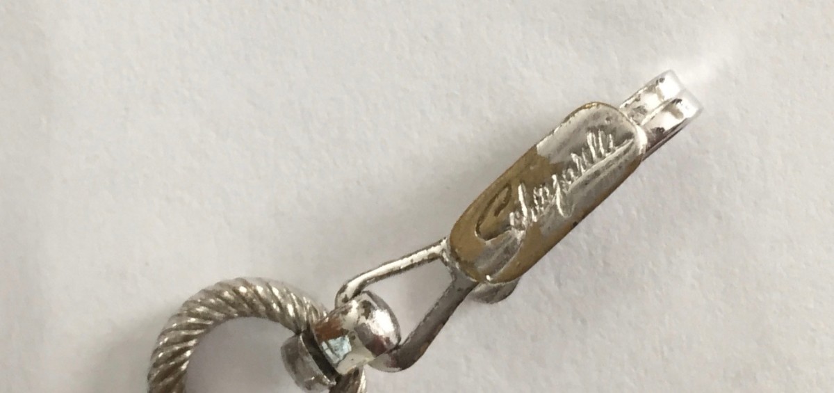 The mark written in script indicates the jewelry piece was produced after 1949.