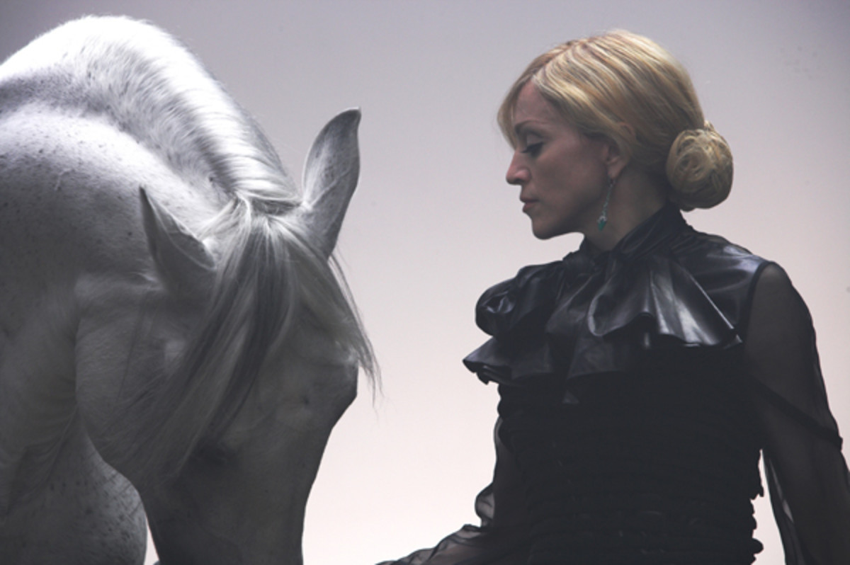 Madonna in an intimate picture with one of her horses for a magazine shoot