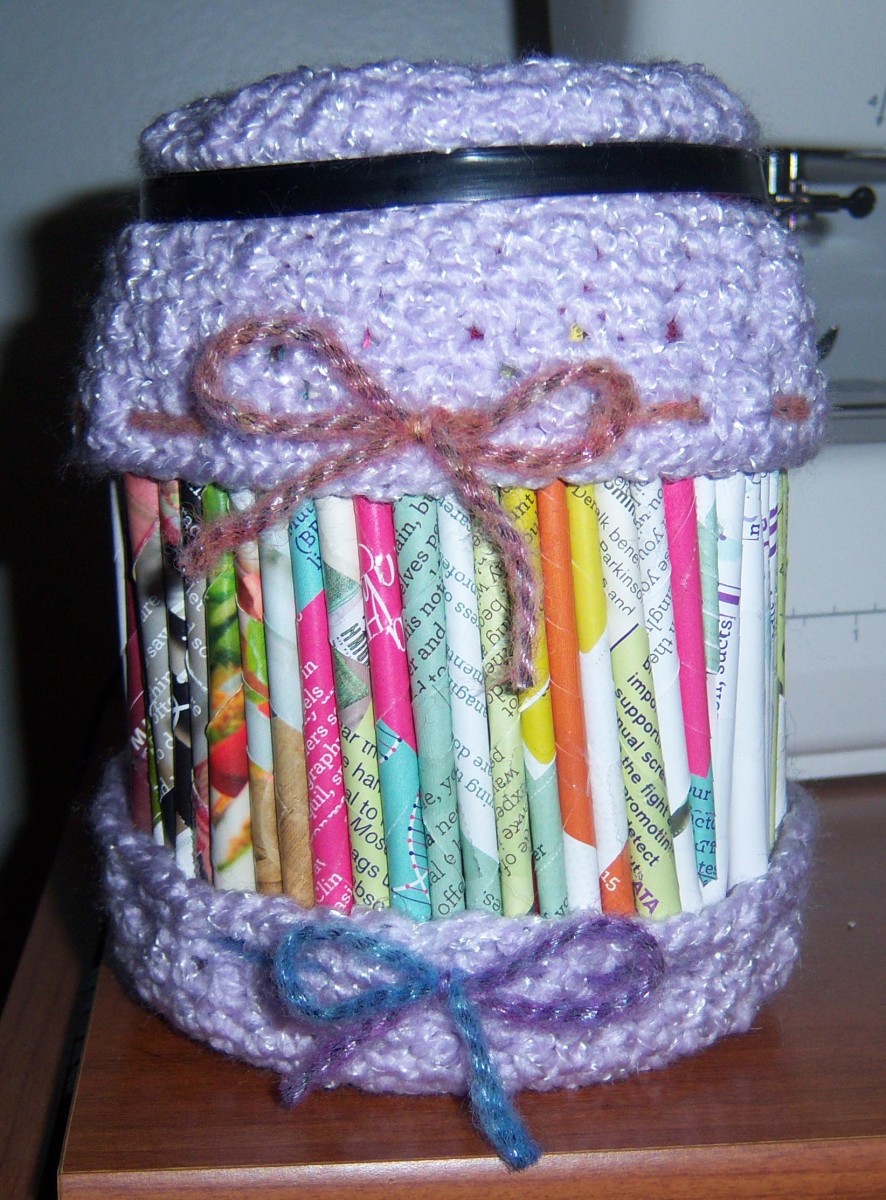 An upcycled coffee can decorated with pages from a magazine and crochet. It'll hold more holiday goodies by the time I'm finished with the gift.
