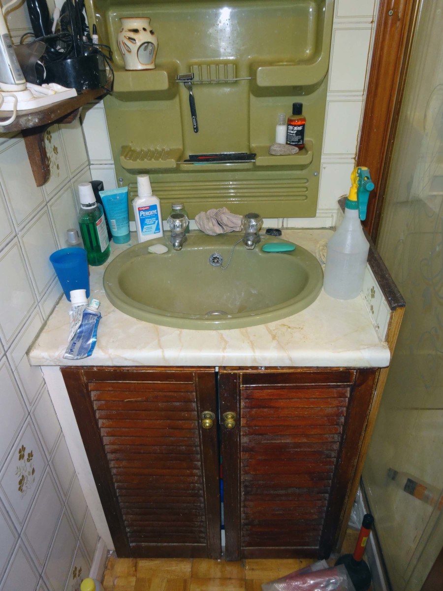Old bathroom wash basin and cjupboard