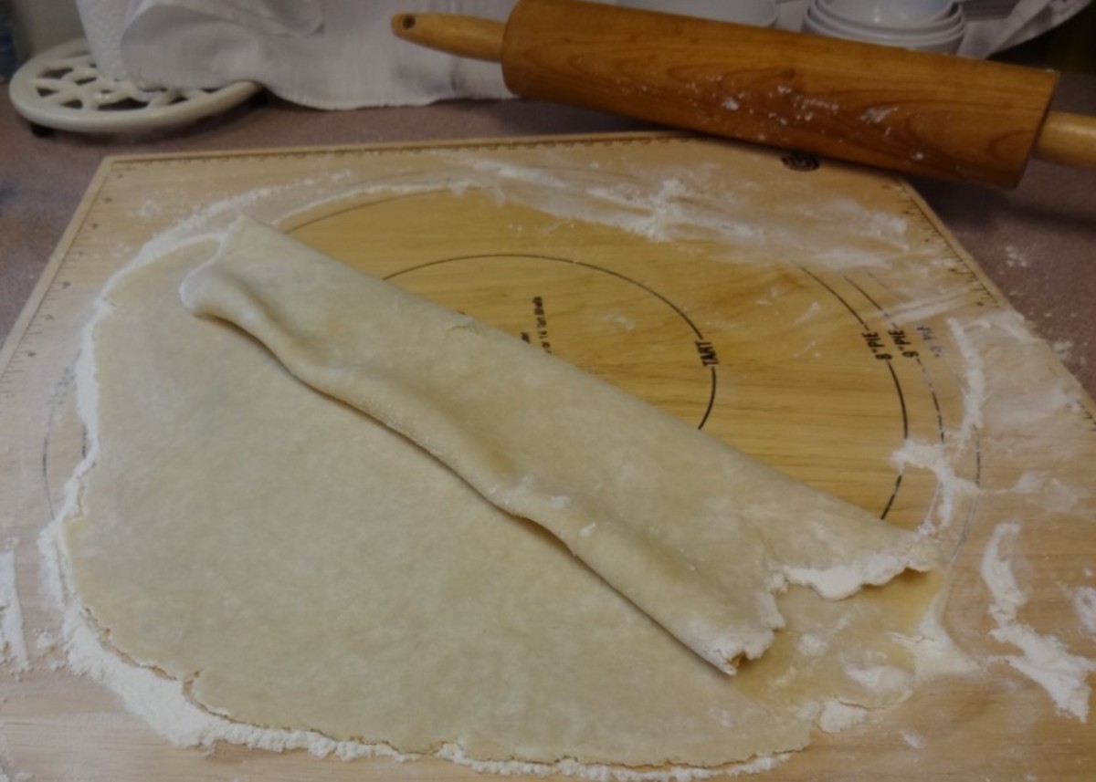 Transfer the dough to a pie pan by folding up the edges with a spatula