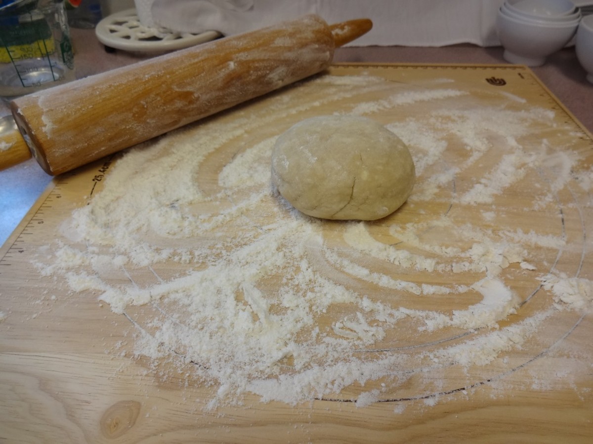 Start by rolling the dough out on a pastry board dusted in flour