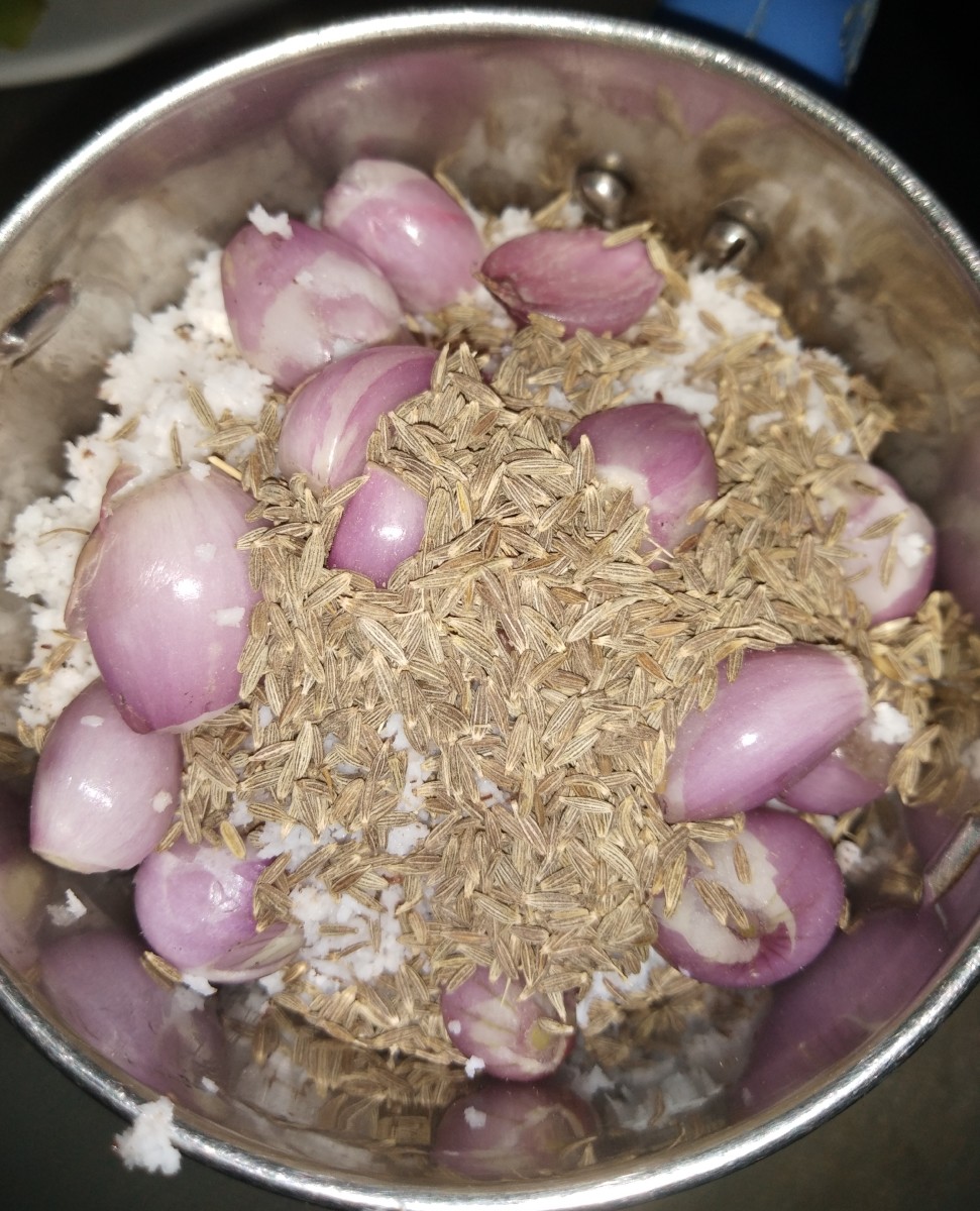 In a small mixer jar take fresh grated coconut. To this add 8-10 shallots or sambar onions and 1 teaspoon of cumin seeds.