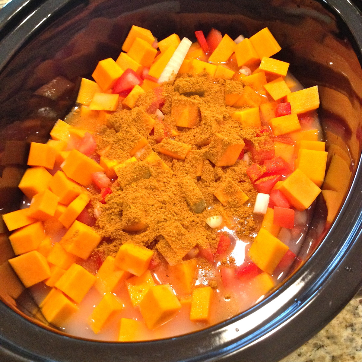 Add chopped vegetables, coconut milk, vegetable broth, curry powder and turmeric to slow cooker.