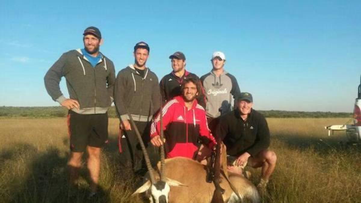 Hunters Pose With A dead Animal