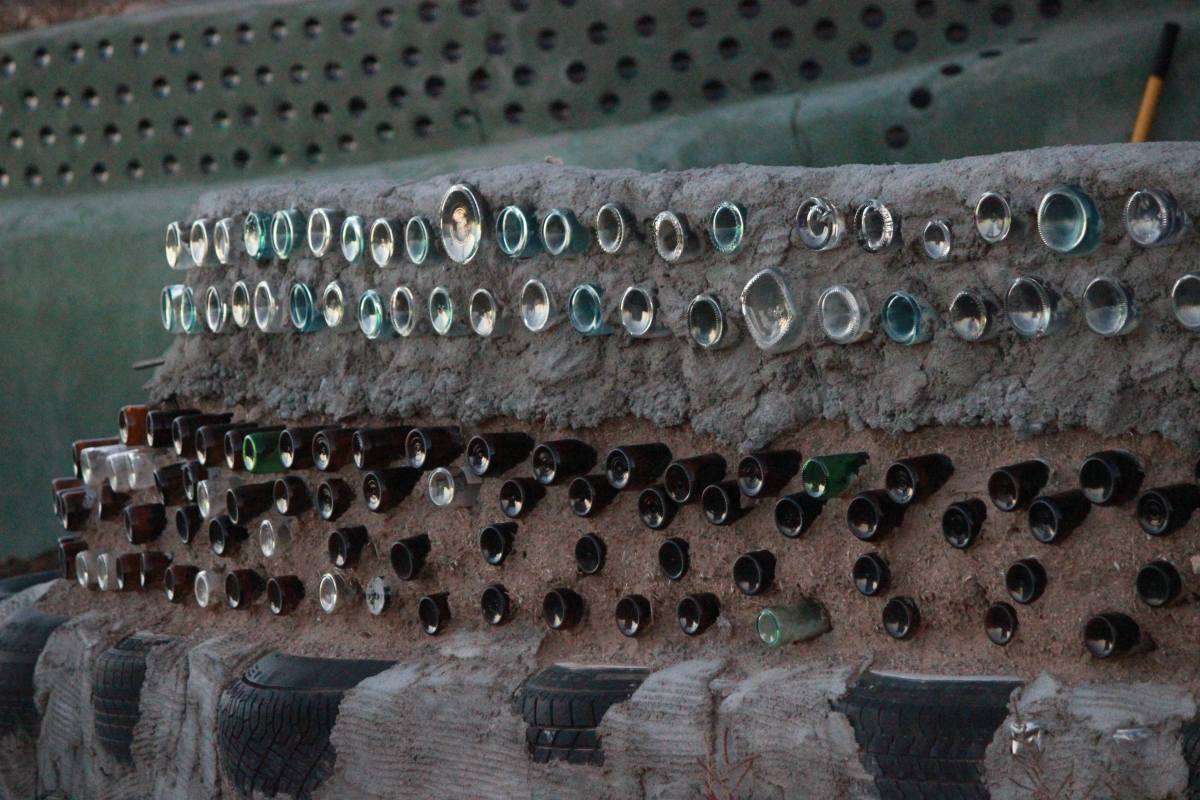 Earthship of Taos, New Mexico.  Recycled bottles make up the bulk of this decorative fence.