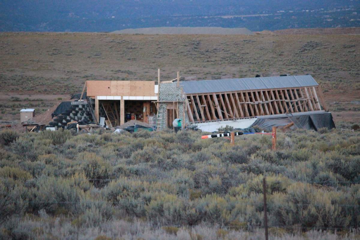Earthships of Taos, New Mexico.  A wood-framed Earthship in progress.  The wood framing is probably required by building codes.