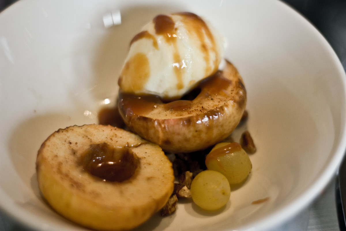 Baked lady apples with vanilla ice cream, rum soaked raisins, toasted pecans, and butterscotch sauce.