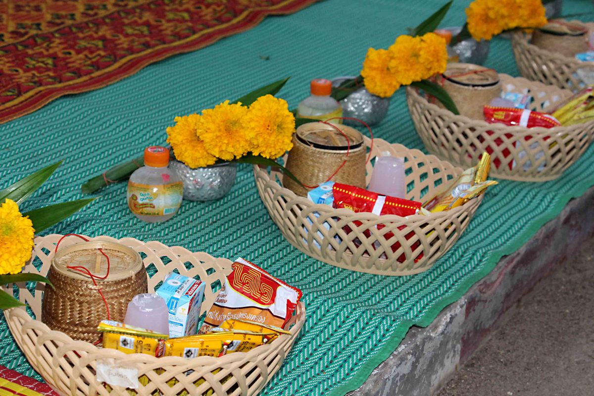 Baskets of food and drink which are laid out on the pavement for the devotees in advance of the monks' arrival