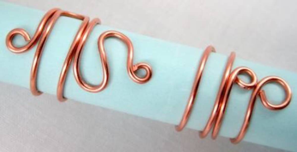 Use round-nose pliers for jewelry tools to create simple and inexpensive copper, gold and silver wire napkin rings.