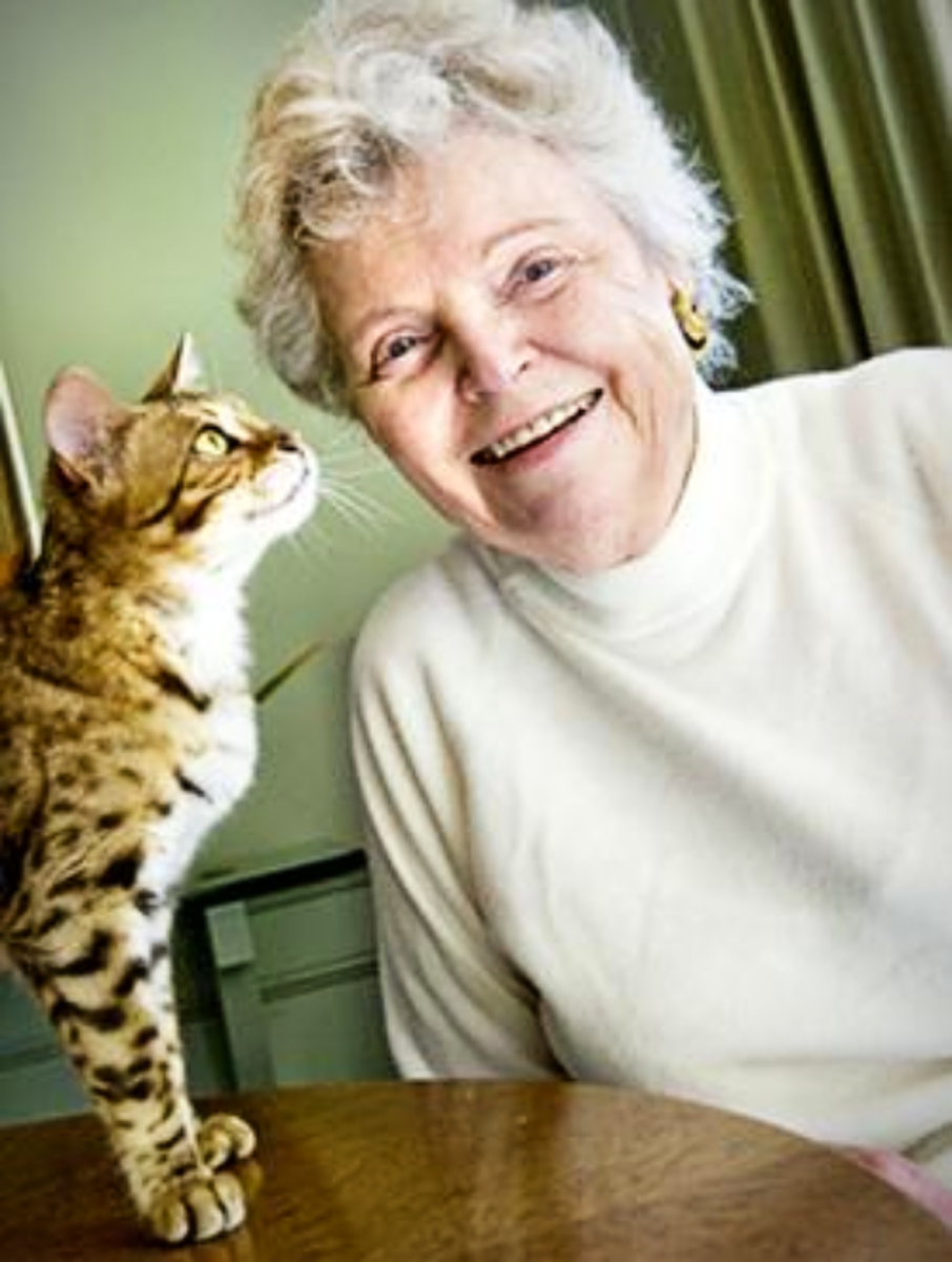 Jean Mill posing with a Bengal Cat
