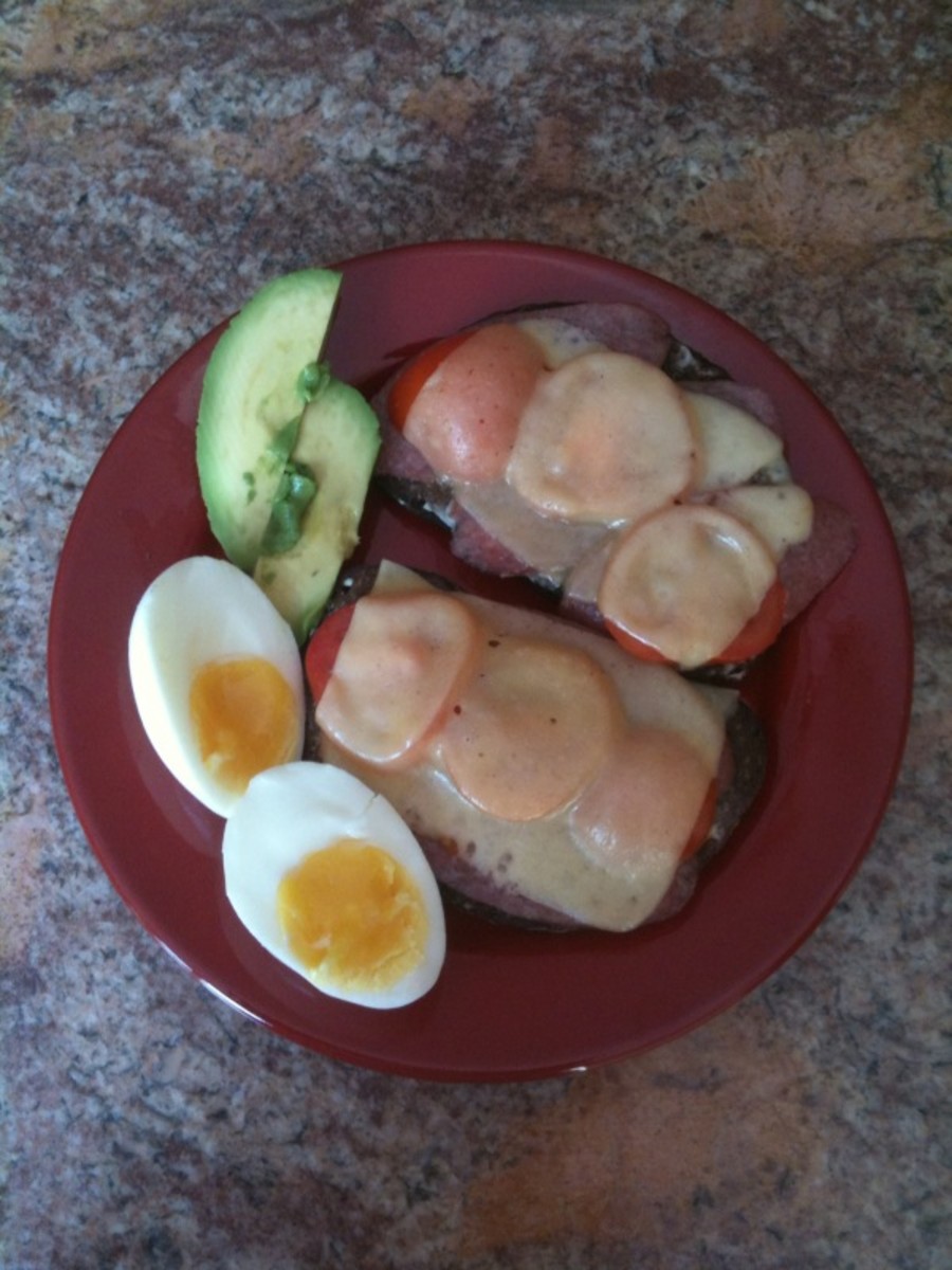 salami and melted cheese sandwich, avocado slices, hard boiled egg